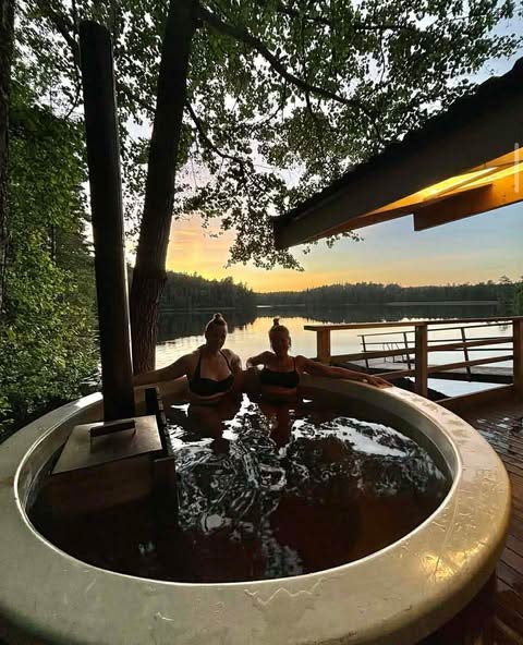 Guests enjoying hot tub at sunset