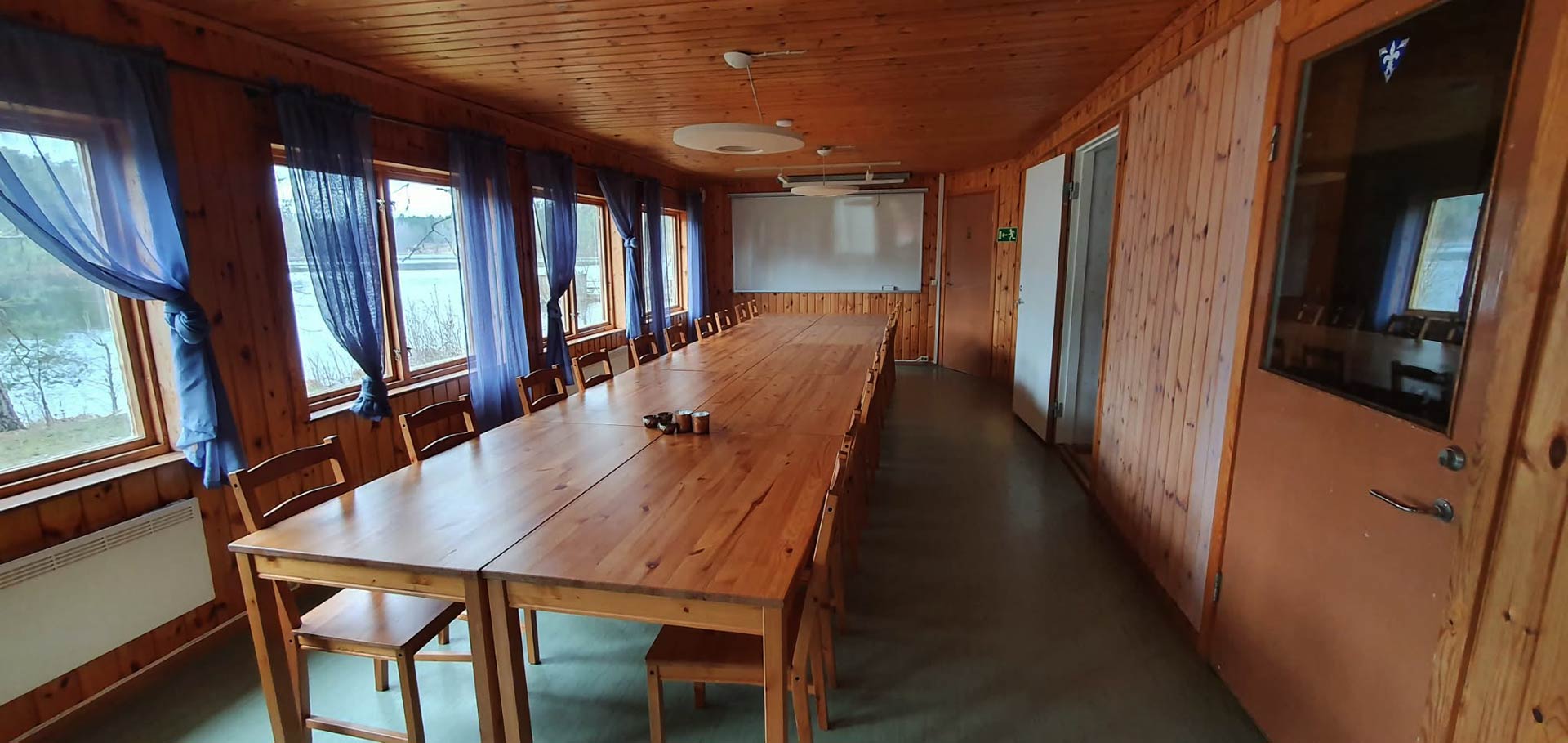 Conference room with long wooden table and lake view