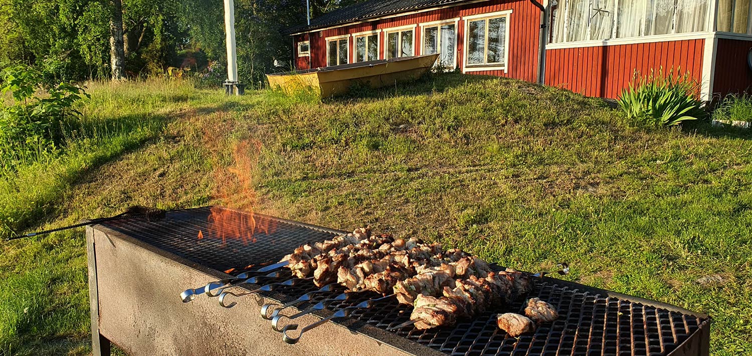 BBQ area with red cabin in background