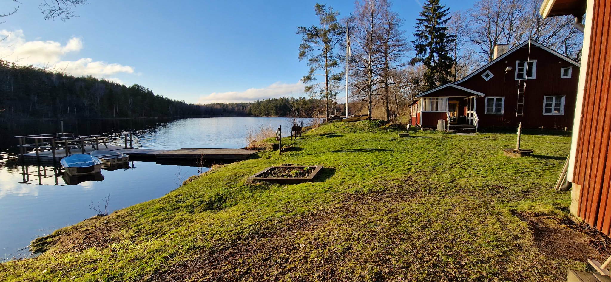 Classic red Swedish cabin with dock by the lake